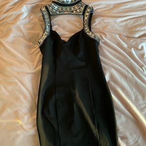 black mini dress with silver jewelry high neck
